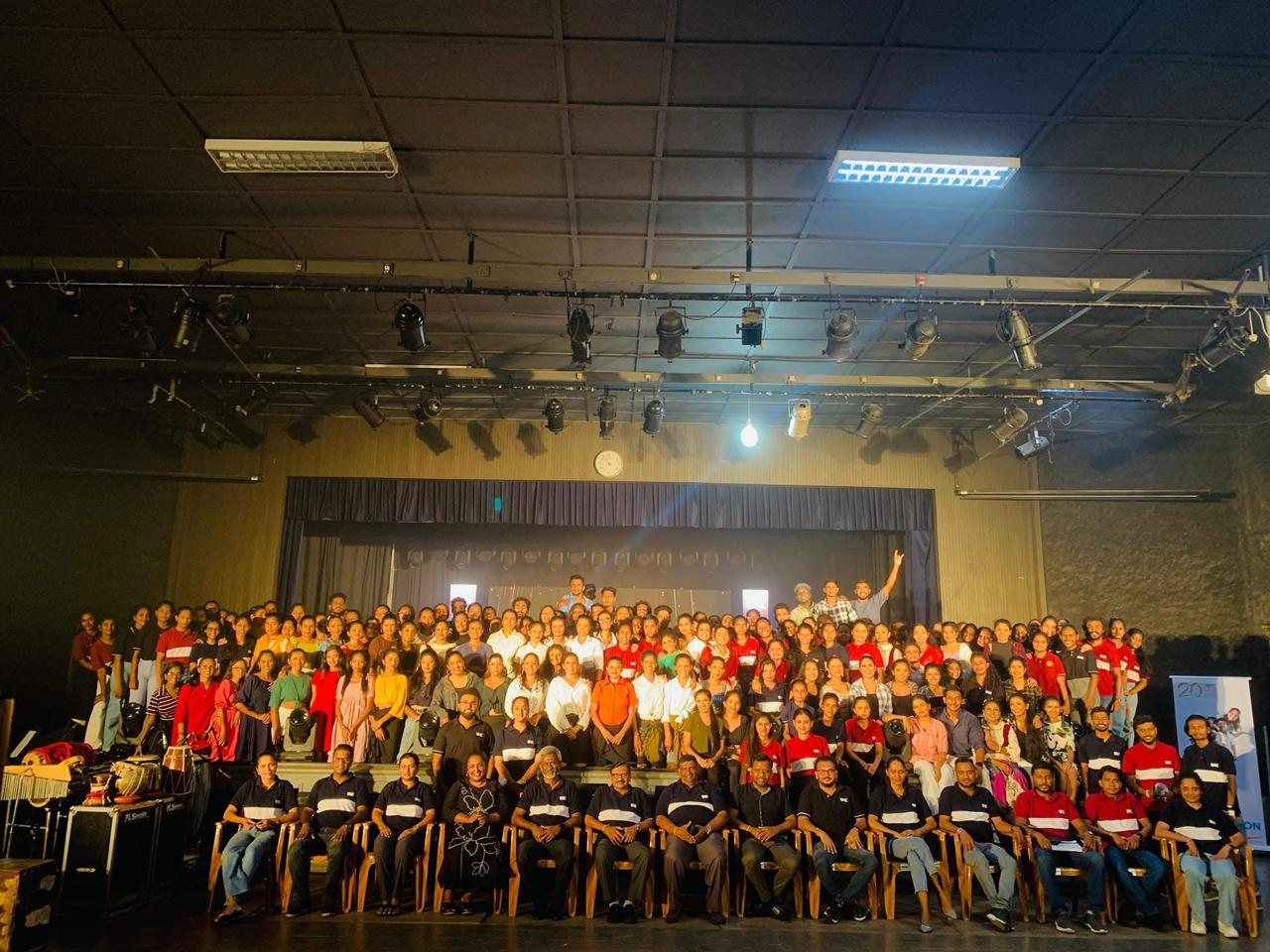 Full cast and crew group photo in the auditorium